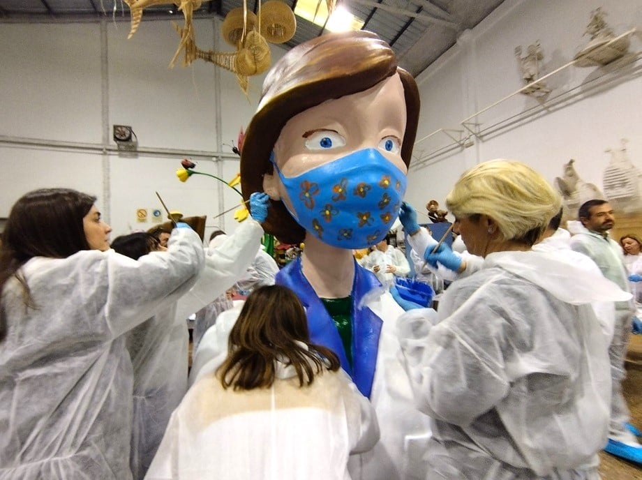 People painting a ninot of a falla in Valencia