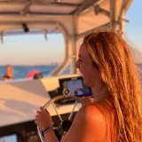 Skipper at the helm of the boat during navigation
